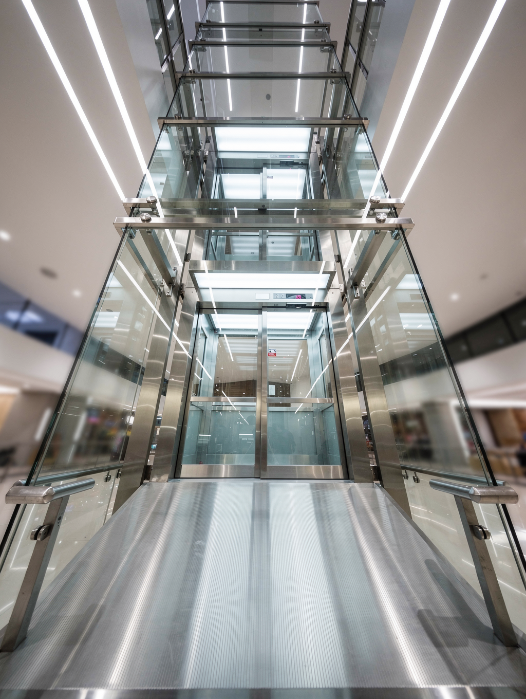 Modern glass observation elevator in a high-rise atrium